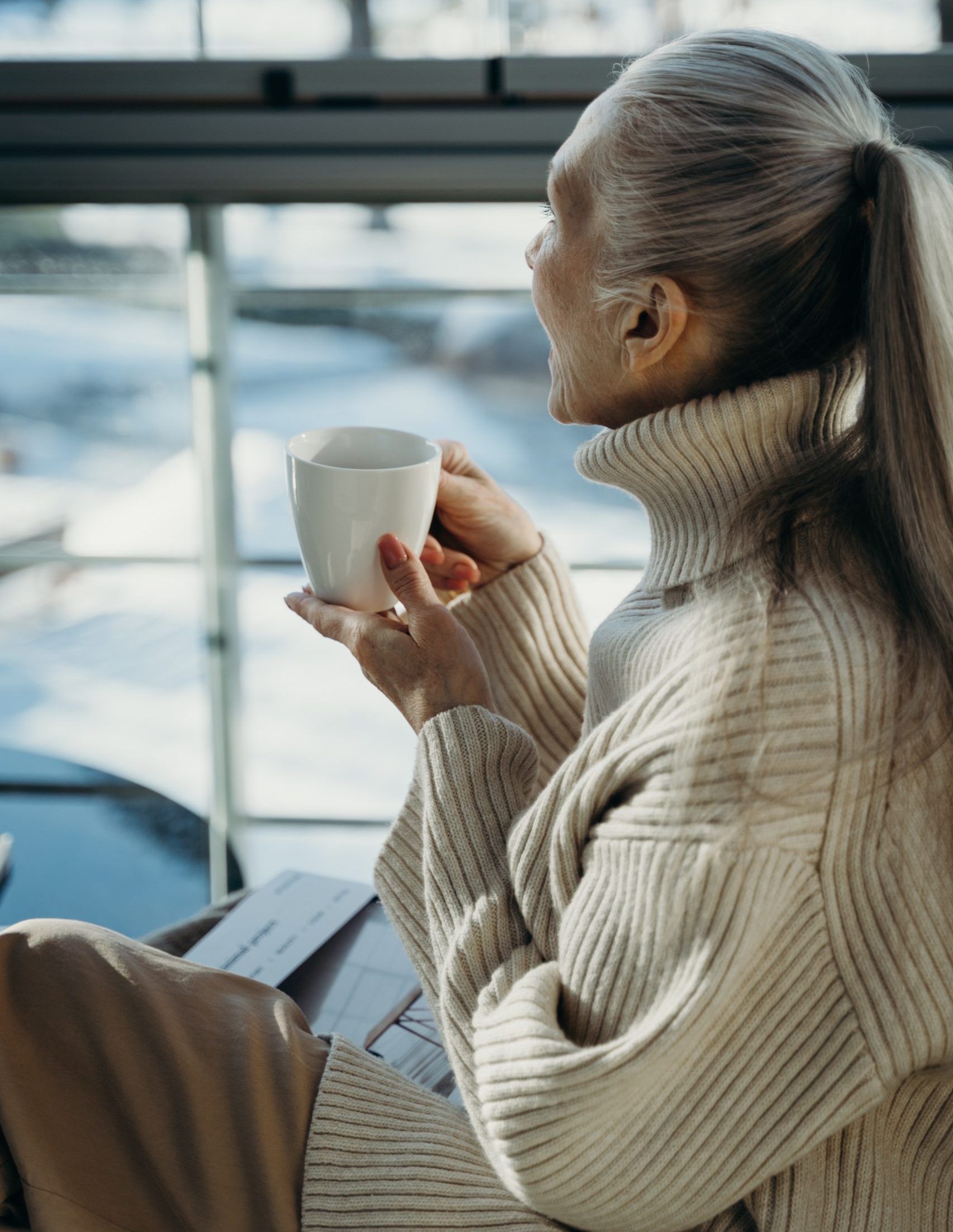 Elderly woman holding a cup of coffee